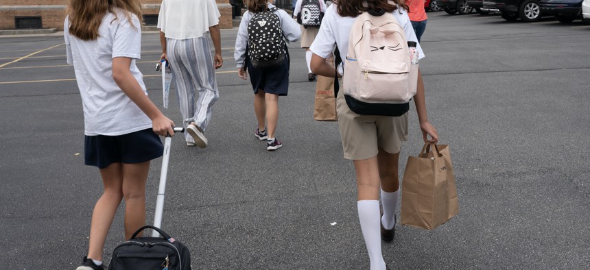 Students walking in to the first day of school at St. Francis of Assisi Catholic Academyon September 9, 2020.