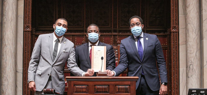 New York State Senators Jamaal Bailey, Brian Benjamin, and Zellnor Myrie holding the senate bill that repeals section 50-A.