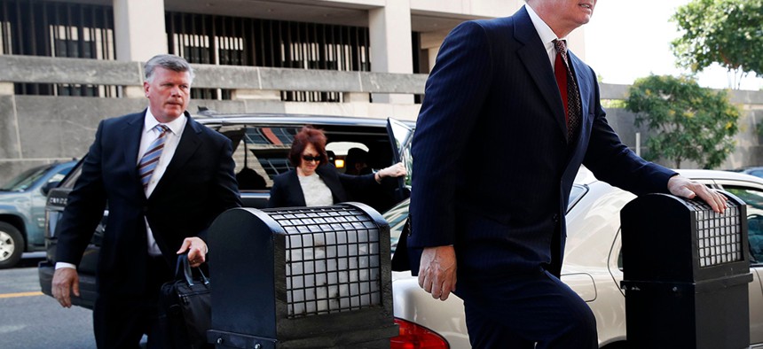 Paul Manafort, right, arrives at federal court in Washington D.C. accompanied by his lawyer Kevin Downing, left, and wife Kathleen Manafort.