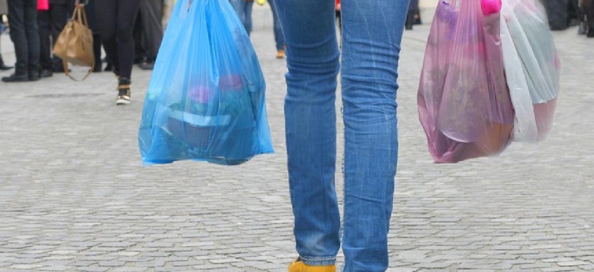 Woman carrying plastic bags