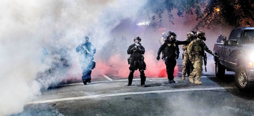 Federal officers use crowd control munitions to disperse Black Lives Matter protesters in Portland on July 21st.