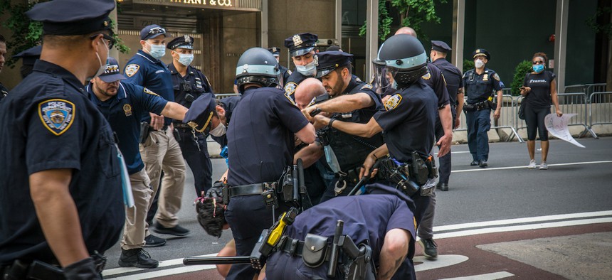 NYPD officers tackling a protestor on May 30th. 