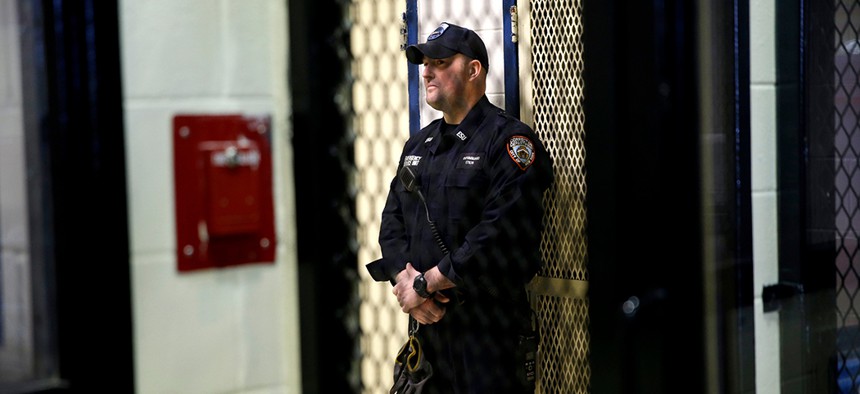 A corrections officer waits outside a cell inside the Rikers Island jail complex.