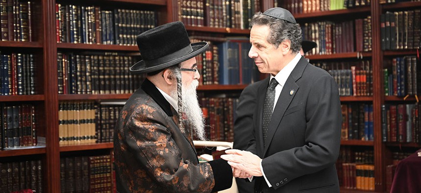 Gov. Andrew Cuomo visits with Rabbi Chaim Rottenberg at his home where multiple people were stabbed while celebrating Hanukkah on Sunday. 