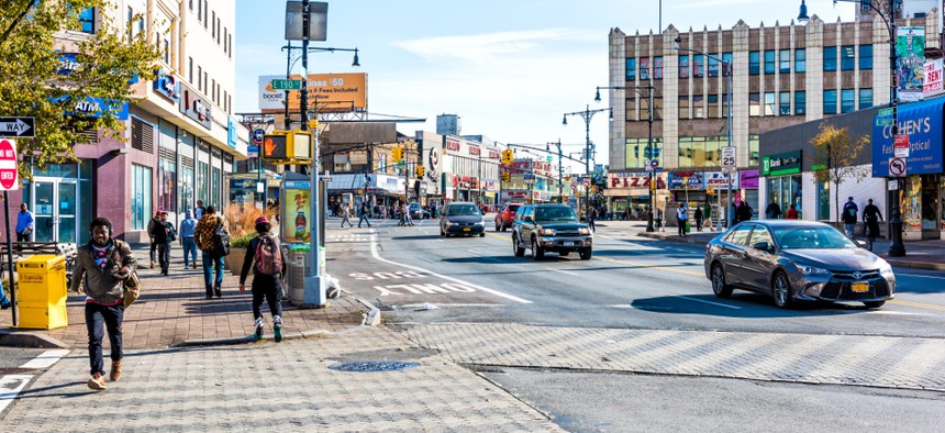 People cross the street in the Fordham Heights section of the Bronx.