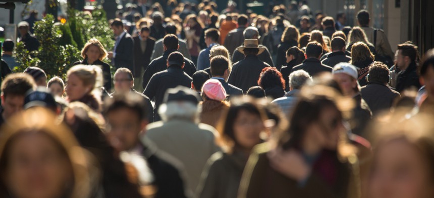 Crowd of anonymous people walking on busy New York City street