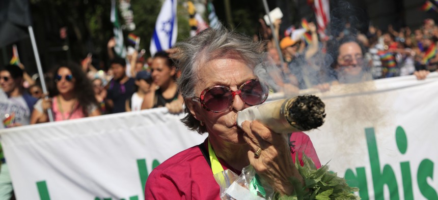 A marijuana advocate puffs on a fake joint during the New York City Pride Parade in 2016.