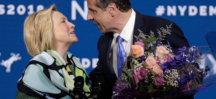 Hillary Clinton is greeted by Gov. Andrew Cuomo after speaking during the state Democratic convention in Hempstead.