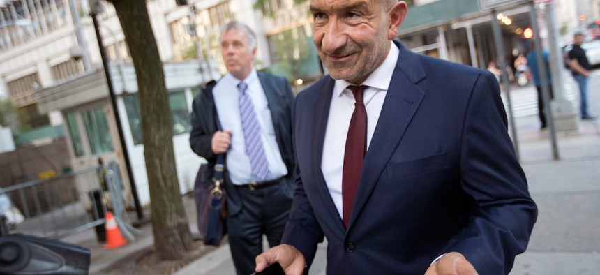 Alain Kaloyeros, right, leaves federal court in New York. 