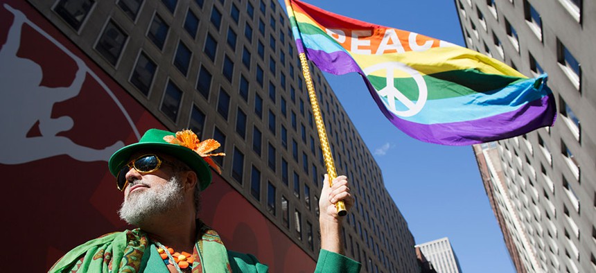 Steven Menendez waves the Gay Pride flag as he waits for the St. Patrick's Day parade to begin in New York, 2016.