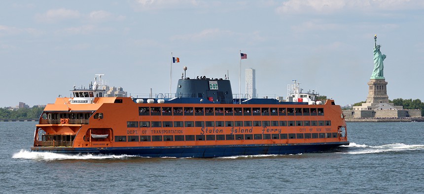 Staten Island Ferry passing in front of the Statue of Liberty