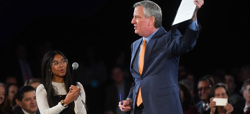 Mayor Bill de Blasio, alongside climate activist Rebeca Sabnam, signs an Executive order banning a new fossil fuel infrastructure at the State of the City address this Thursday.