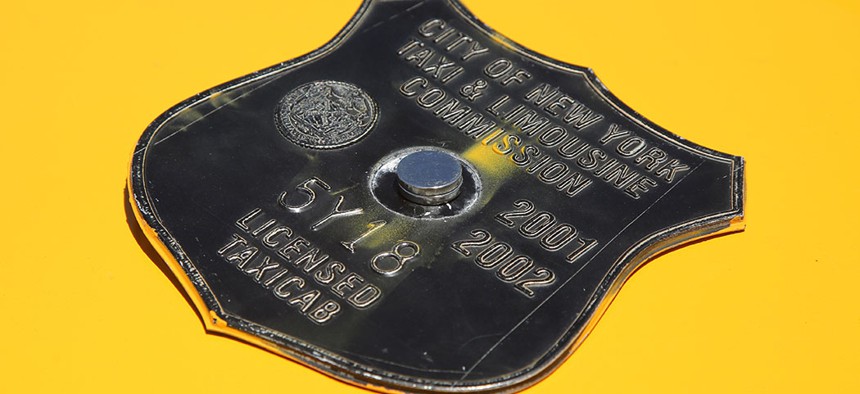 A vintage New York City taxi medallion.