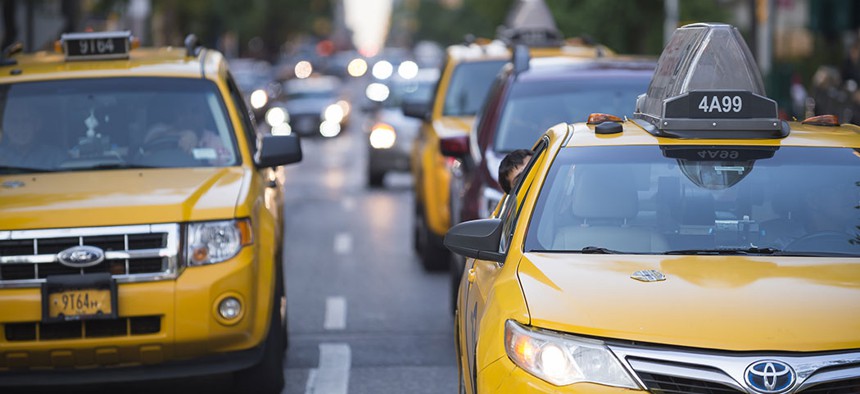 Taxis driving throughout the city.