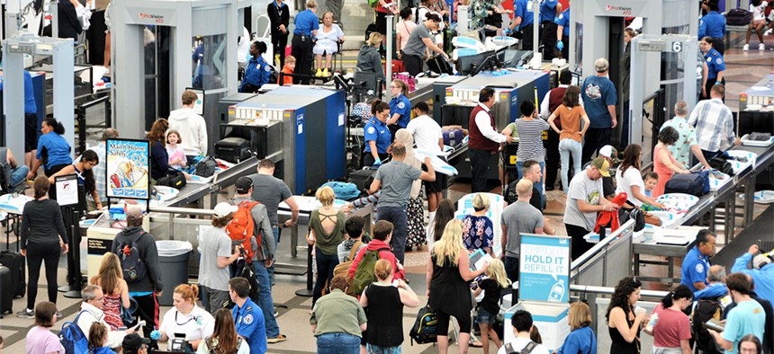 Travelers going through airport security.