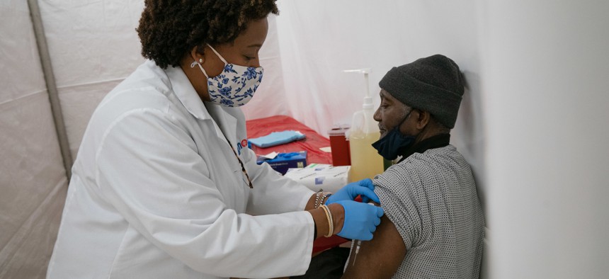 Dr. Jacqueline Delmont, Chief Medical Officer at Somos delivers the COVID-19 vaccine at St. Luke's church in the Bronx.