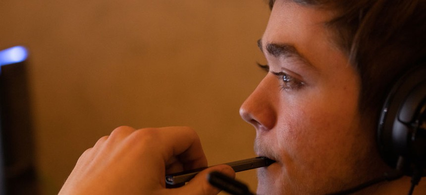 A teen using an e-cigarette.