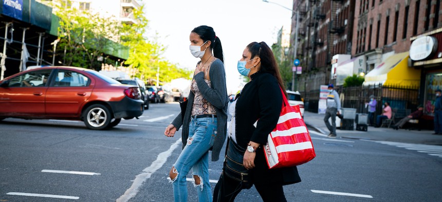 A woman and her daughter walking in the Washington Heights neighborhood in Manhattan.