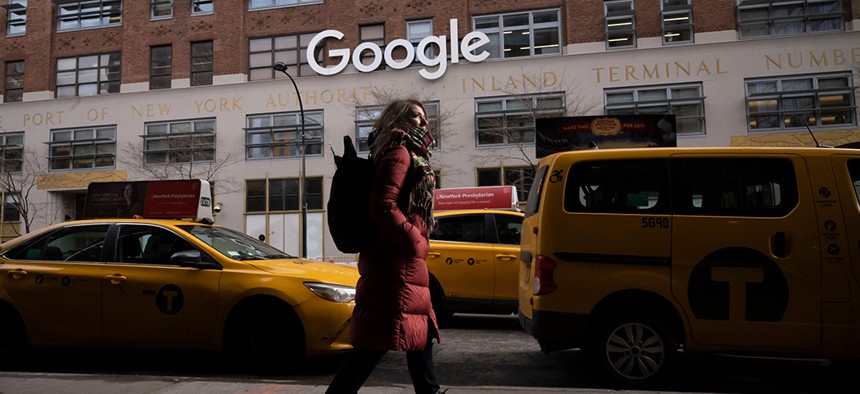 A woman walks past the Google offices in Manhattan New York
