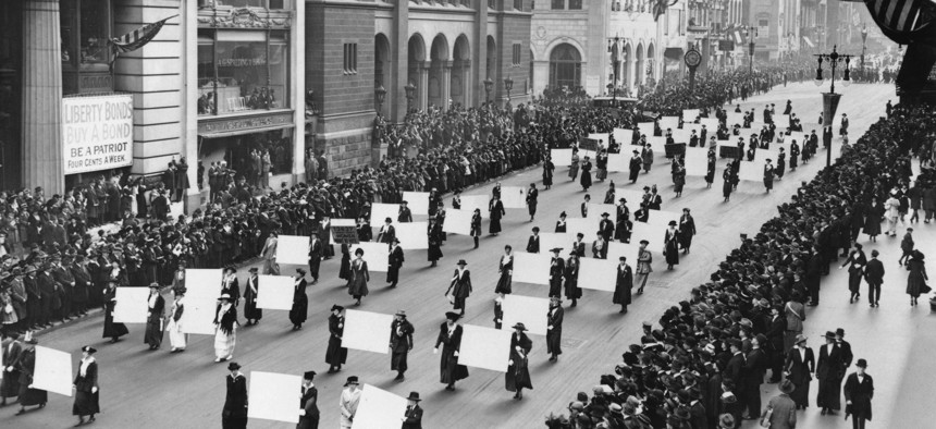 Suffragists march down Fifth Avenue in October 1917, displaying placards containing the signatures of more than 1 million New York women demanding the right to vote.