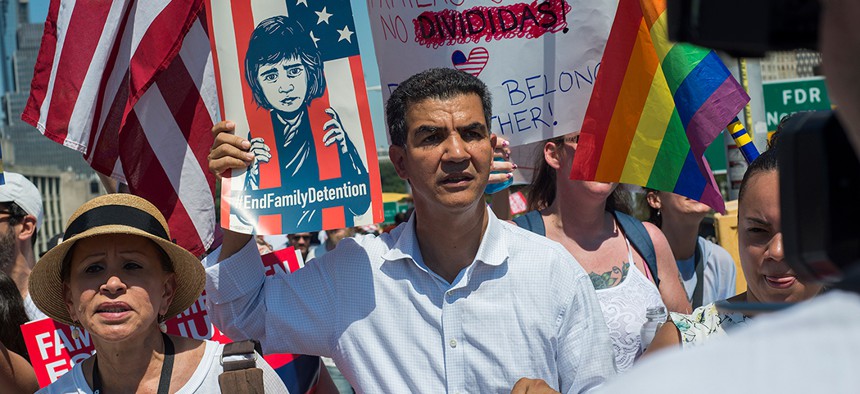 New York City Councilman Ydanis Rodriguez [center] and Rep. Nydia Velazquez [left] take part in the Families Belong Together March in New York City.