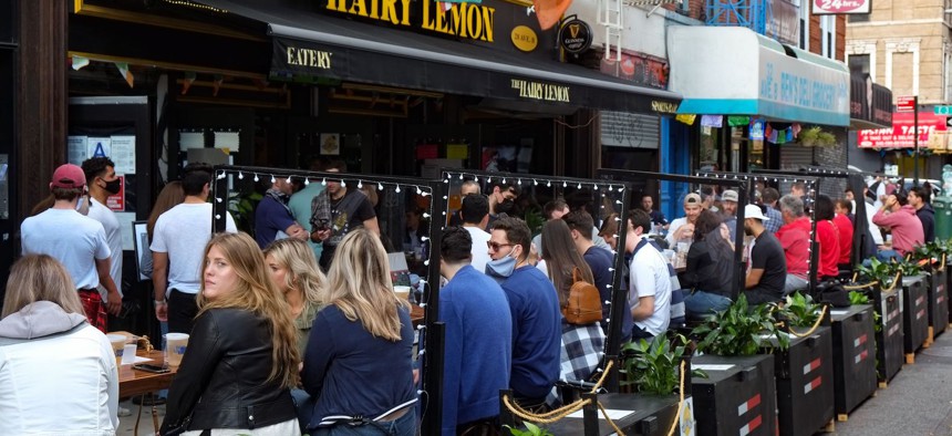 People sitting outside at a bar in Alphabet City on October 24th.