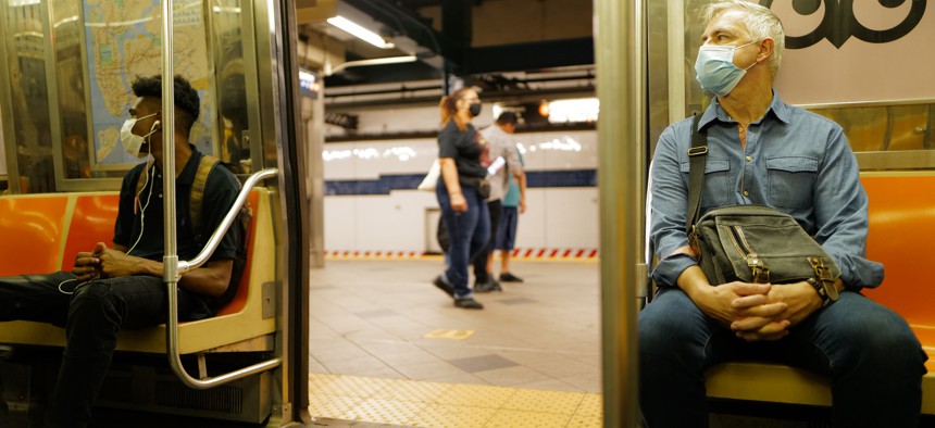 New Yorkers masked riding the subway.