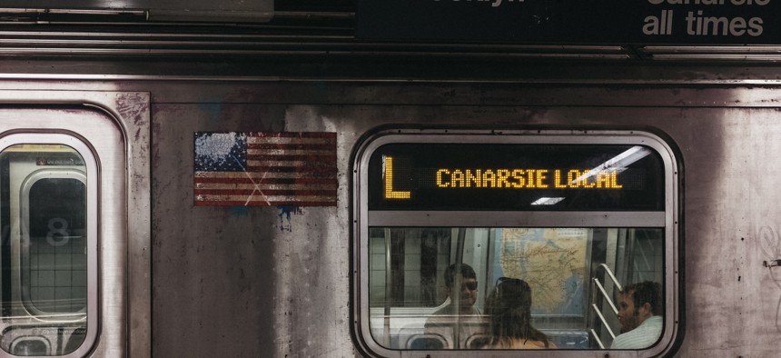 Canarsie local subway L train stops at a station