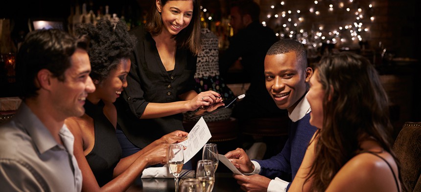 Photo of a waitress taking an order in a restaurant