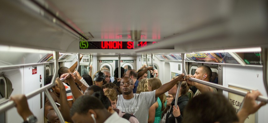 A crowded New York City subway car. 