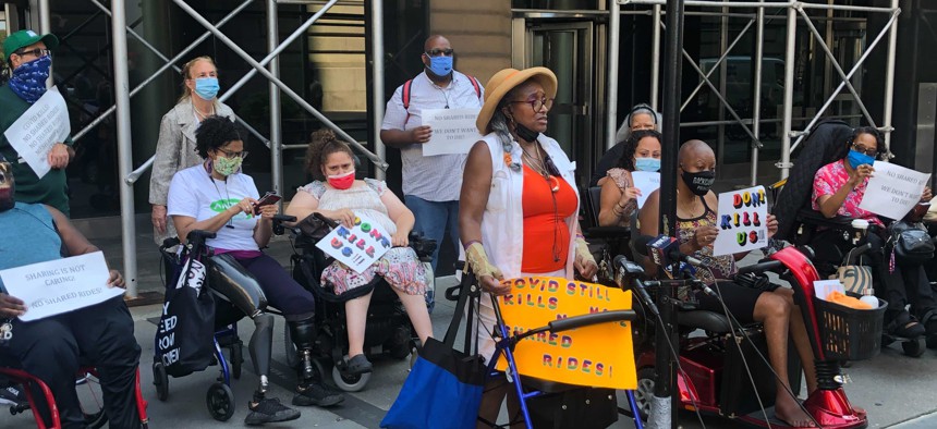 Paratransit users and advocates for people with disabilities rally outside the MTA's headquarters to end shared trips on Access-A-Ride.