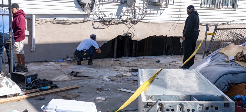 NY Department of Buildings staff inspects the house where people were killed when their basement apartment was flooded during Hurricane Ida.