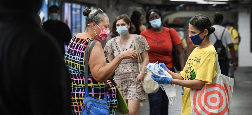 Volunteer handing out masks at the Atlantic Av. - Barclay's Center stop.