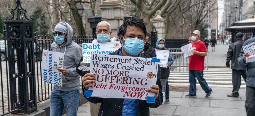 Yellow taxi drivers and medallion owners rally for debt forgiveness at the gates of City Hall