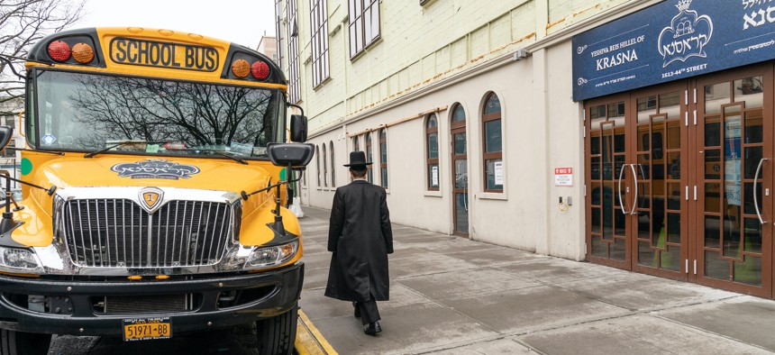 A man walks past the Yeshiva Beis Hillel of Krasna in Borough Park, Brooklyn. 