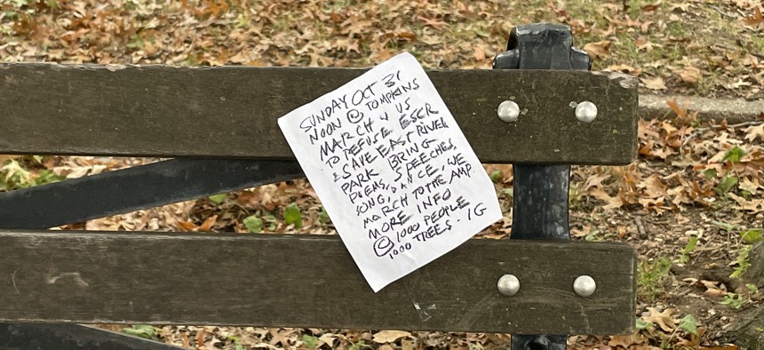 Bench in East River Park with call to action from 1,000 Trees, 1,000 People organization. 