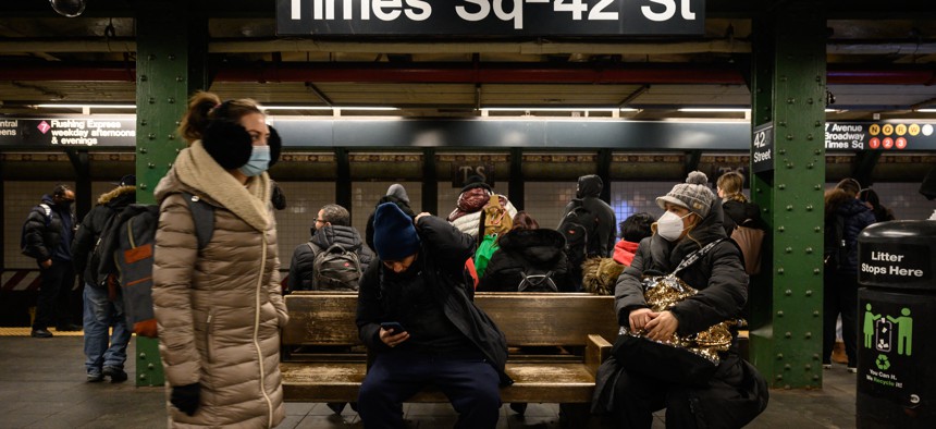 Commuters wait for a train at the Times Square-42nd Street station.