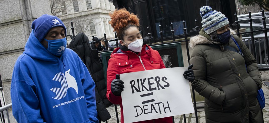 Community activists demanding the closure of Rikers Island.