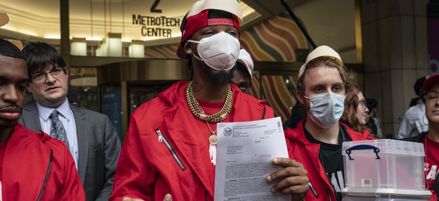 President of the Amazon Labor Union Chris Smalls holding a letter from the NLRB.