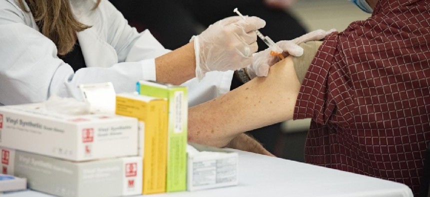 A COVID-19 vaccine being administered