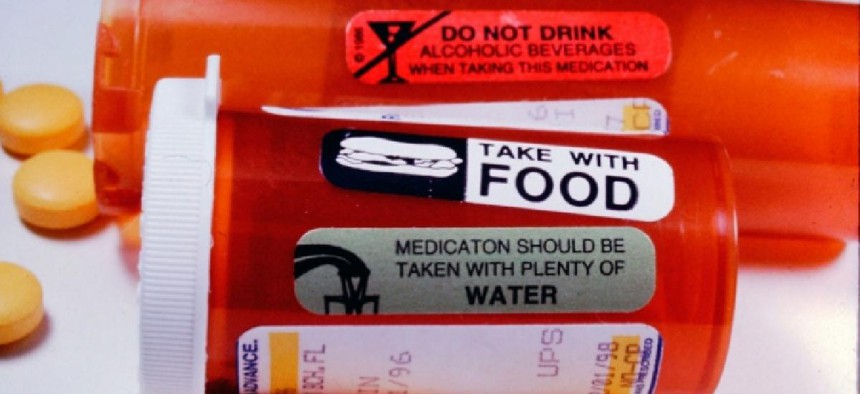 Group of prescription drugs with warning labels about taking with food, water and not alcohol