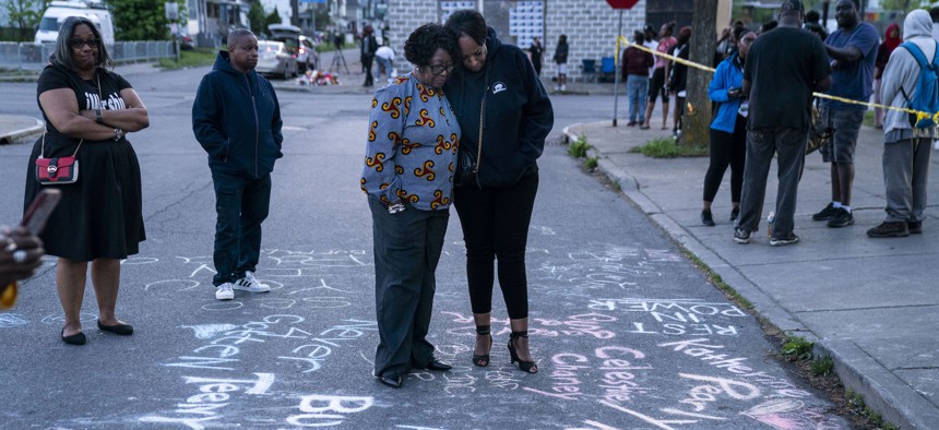 Assembly Majority Leader Crystal Peoples-Stokes comforts a resident near the supermarket where a mass shooter killed 10 people on May 14.