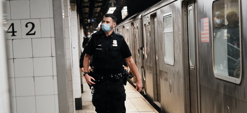 An NYPD officer patrols the subway.