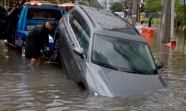 A vehicle is prepared to be towed after it died while being driven through a flooded street caused by a deluge of rain on June 4, 2022 in Miami. 