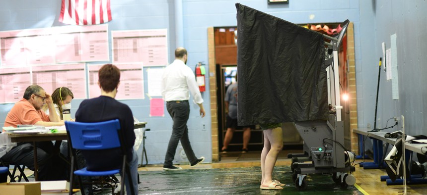 A woman votes at Hillside Recreation Center polling place during the May primary election in Philadelphia.