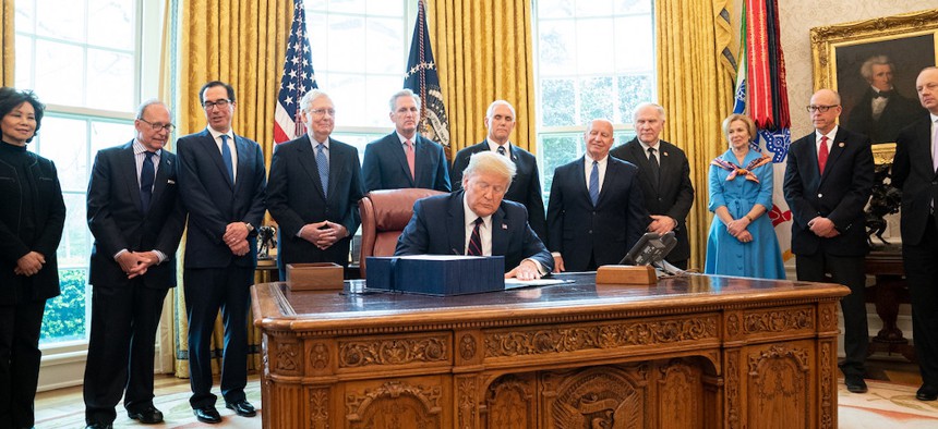 President Trump signing the CARES Act on March 27th.