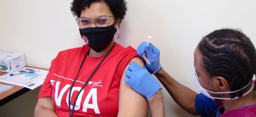 Volunteers of America-Greater New York staff member receives her first dose of the COVID-19 vaccine on-site.