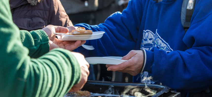 Person handing out food. 