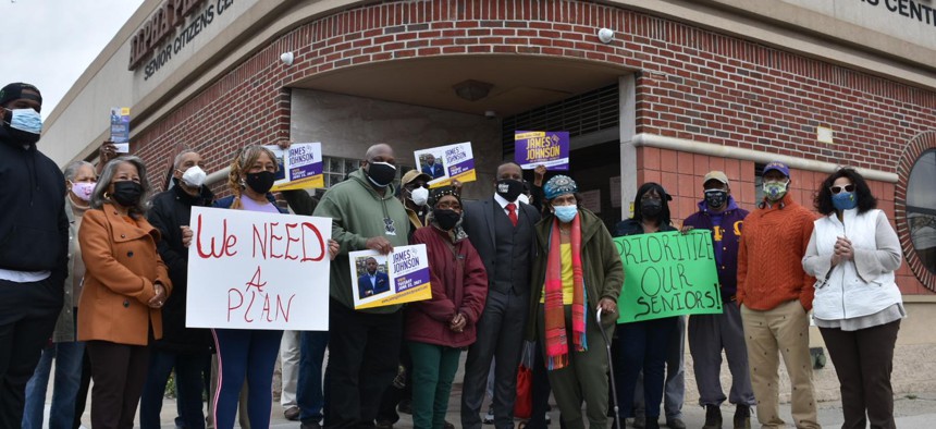 Seniors rally outside a senior center in Queens in March.