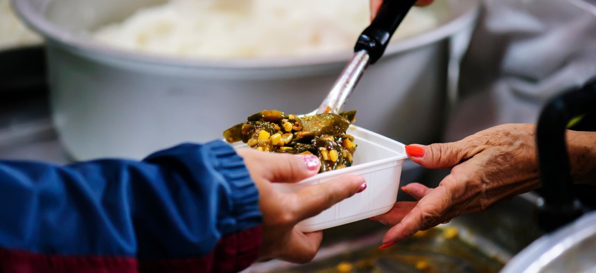 Person gives food to someone else
